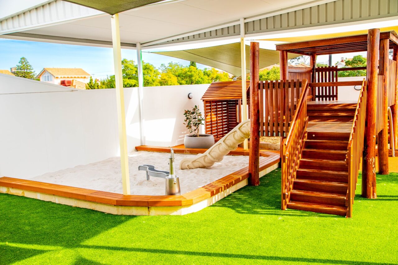 Natural timber Montessori playspace with cubbies, climbing ramps and a water play table at Nurture Montessori Childcare, Victoria Park