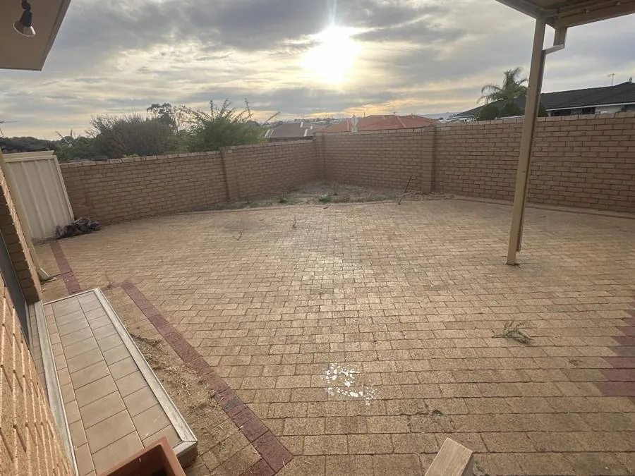 Paved rear yard before artificial grass was installed